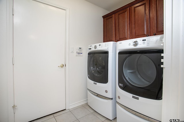 1521 Rice Rd Unit E105, Tyler, TX 75703 - laundry area with washing machine and dryer, cabinet space, and light tile patterned flooring
