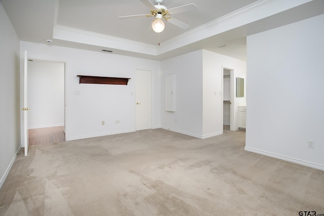 1521 Rice Rd Unit E105, Tyler, TX 75703 - unfurnished living room with a raised ceiling, crown molding, light colored carpet, ceiling fan, and baseboards