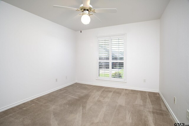 1521 Rice Rd Unit E105, Tyler, TX 75703 - empty room featuring carpet, a ceiling fan, and baseboards