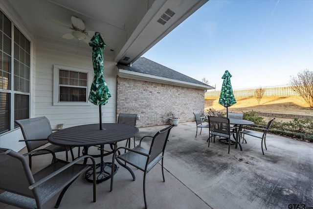 view of patio / terrace featuring fence, a ceiling fan, and outdoor dining space