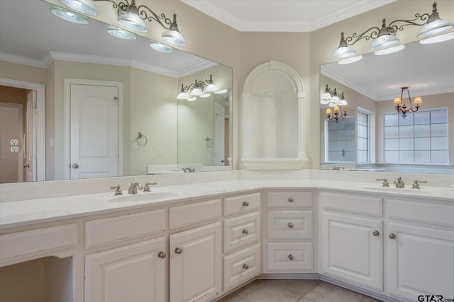 bathroom with double vanity, an inviting chandelier, ornamental molding, and a sink