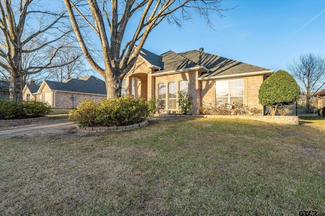 view of front of property featuring a front yard and brick siding