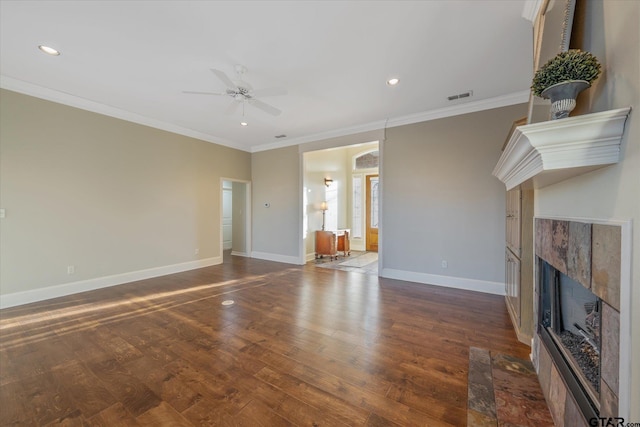 unfurnished living room featuring dark wood-style flooring, visible vents, ornamental molding, a high end fireplace, and baseboards