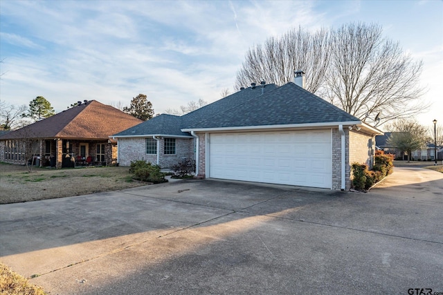 ranch-style house with roof with shingles, driveway, brick siding, and an attached garage