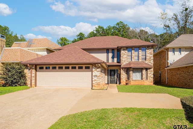 view of front of home featuring a garage and a front yard