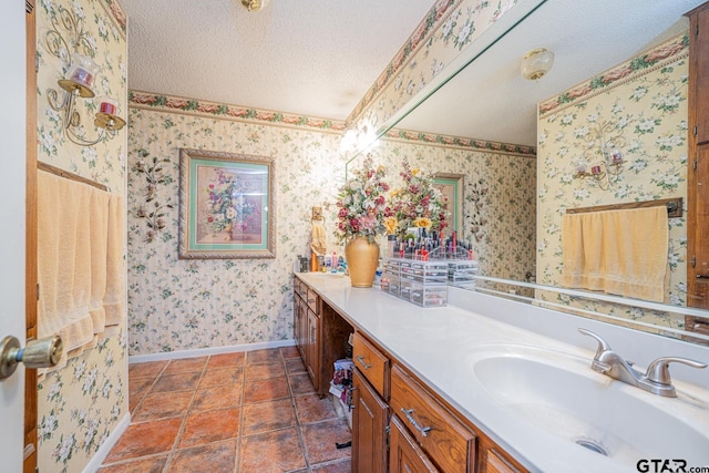 bathroom featuring tile patterned floors, vanity, and a textured ceiling