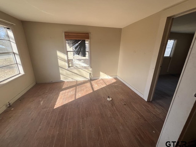 empty room with wood-type flooring and plenty of natural light