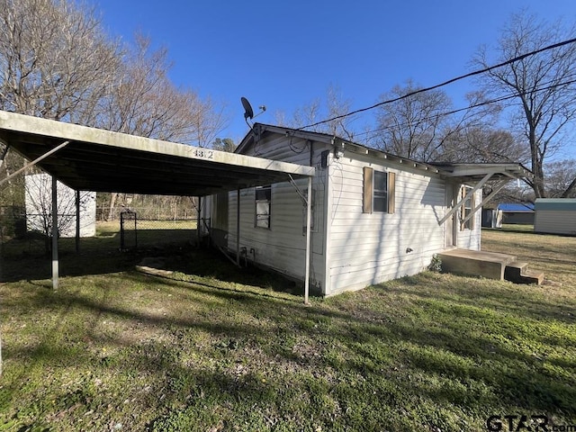 view of property exterior with a lawn and a carport