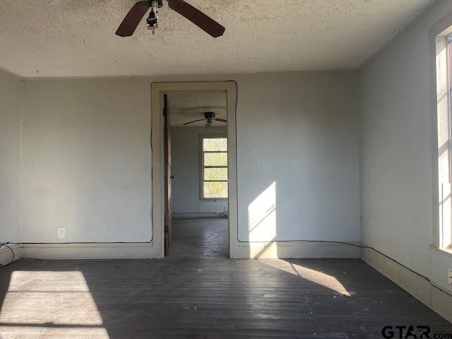 spare room with a textured ceiling and wood finished floors