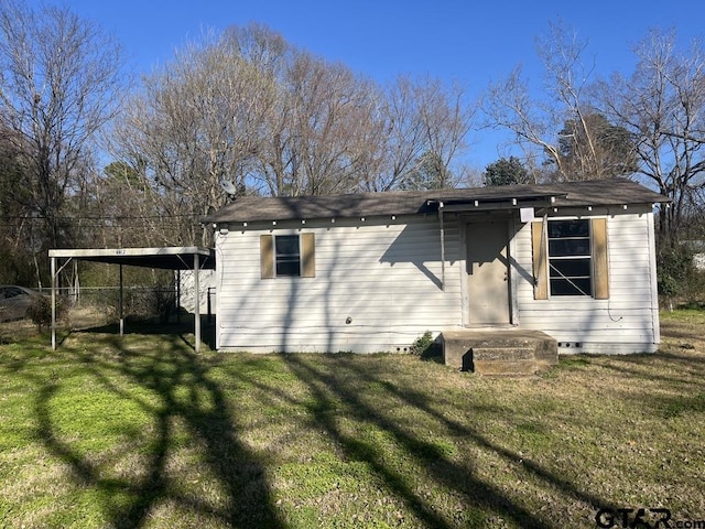 back of house with crawl space and a lawn