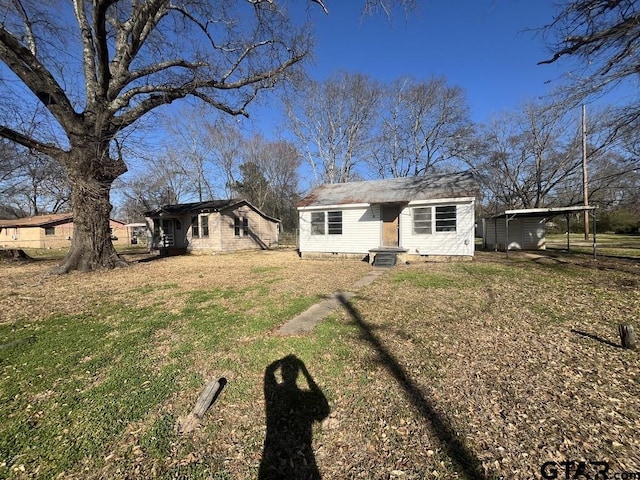 back of property with entry steps, a yard, and crawl space