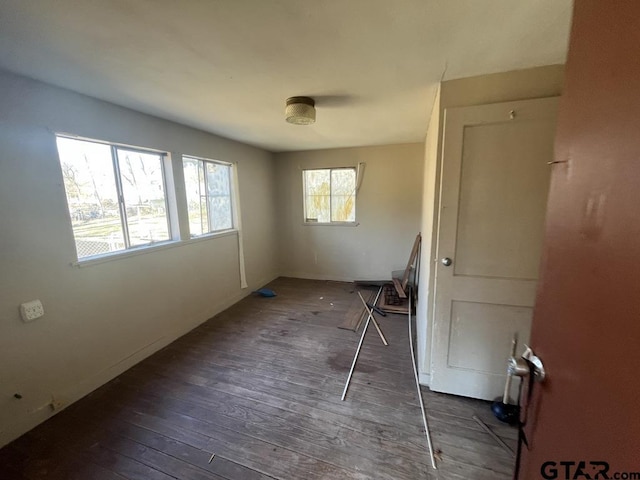 unfurnished room with hardwood / wood-style flooring