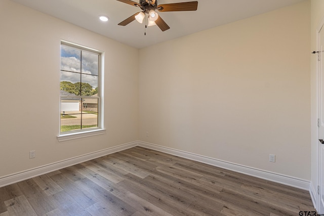 empty room featuring hardwood / wood-style flooring and ceiling fan