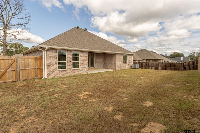 back of house featuring a patio, a lawn, and central air condition unit