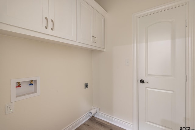 washroom with cabinets, electric dryer hookup, washer hookup, and light wood-type flooring