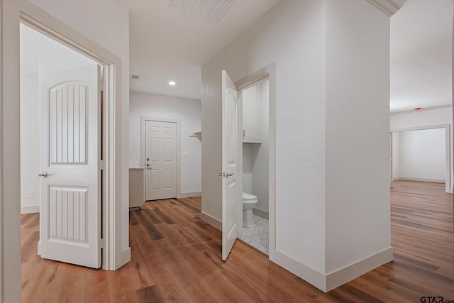 hall with hardwood / wood-style flooring