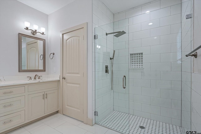 bathroom with an enclosed shower, vanity, and tile patterned floors