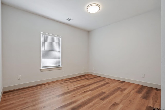 spare room featuring wood-type flooring