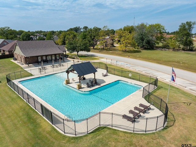 view of swimming pool featuring a patio and a lawn