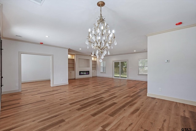 unfurnished living room featuring light wood-type flooring, ornamental molding, and ceiling fan with notable chandelier