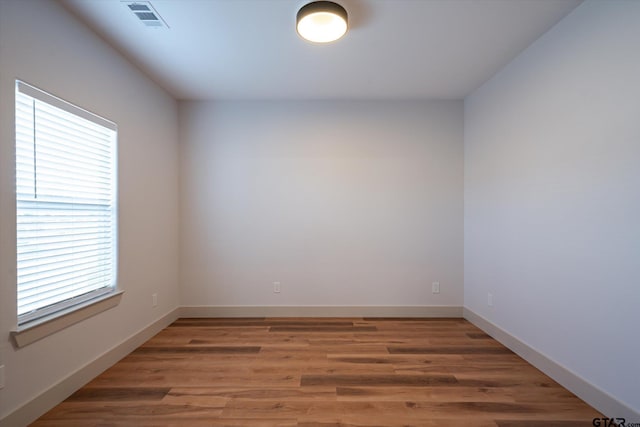 spare room with dark hardwood / wood-style flooring