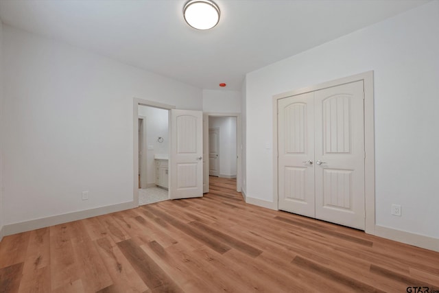 unfurnished bedroom with light hardwood / wood-style flooring and a closet