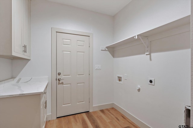 washroom with light hardwood / wood-style floors, electric dryer hookup, cabinets, gas dryer hookup, and washer hookup