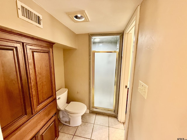 bathroom with tile patterned floors, toilet, and walk in shower