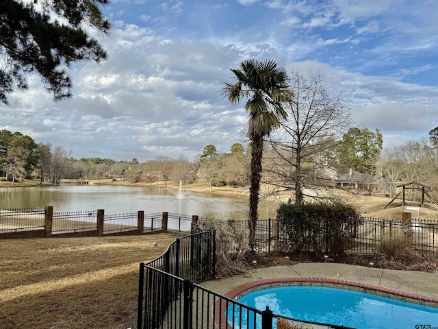 view of swimming pool featuring a water view