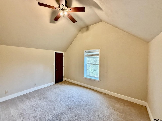 additional living space featuring lofted ceiling, ceiling fan, and carpet