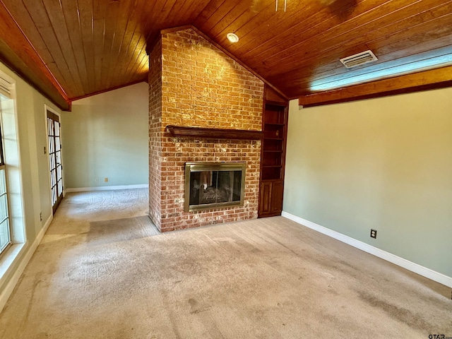 unfurnished living room featuring light carpet, a brick fireplace, wood ceiling, and built in shelves