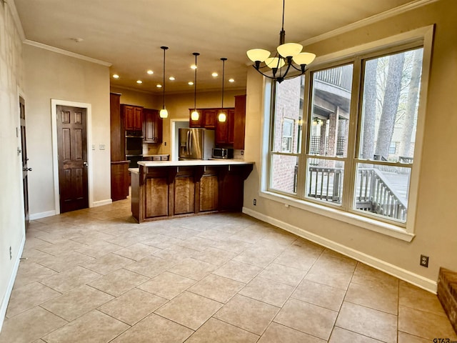 kitchen featuring a healthy amount of sunlight, stainless steel appliances, decorative light fixtures, and kitchen peninsula