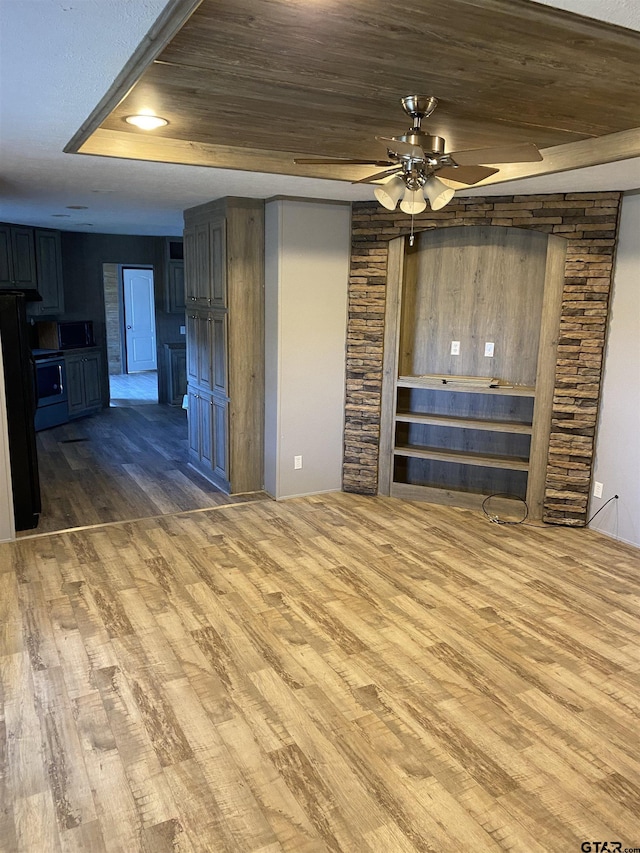 unfurnished living room with ceiling fan, wood-type flooring, and wood ceiling