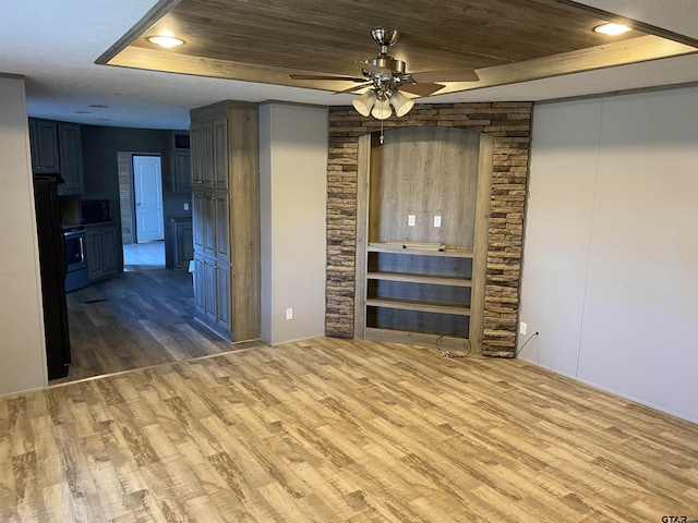 unfurnished living room with hardwood / wood-style flooring, ceiling fan, a raised ceiling, and wooden ceiling