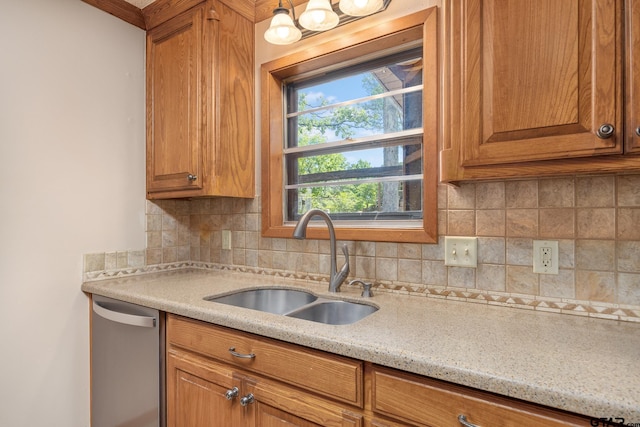 kitchen featuring stainless steel dishwasher, a sink, brown cabinetry, decorative backsplash, and light stone countertops
