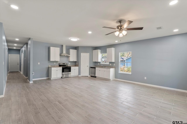 unfurnished living room with ceiling fan and light hardwood / wood-style floors