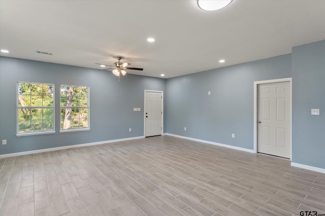 empty room featuring light wood-type flooring and ceiling fan