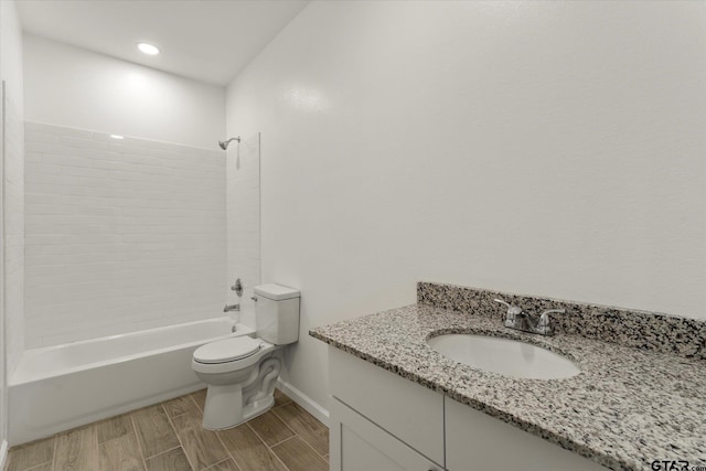 full bathroom with toilet, vanity, hardwood / wood-style flooring, and shower / washtub combination