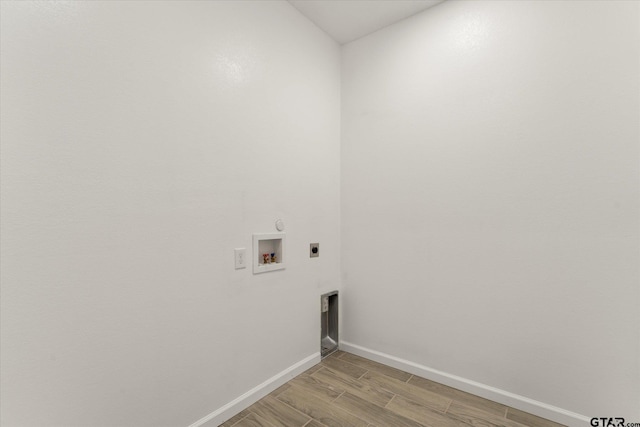 washroom featuring hookup for a washing machine, electric dryer hookup, and light hardwood / wood-style flooring