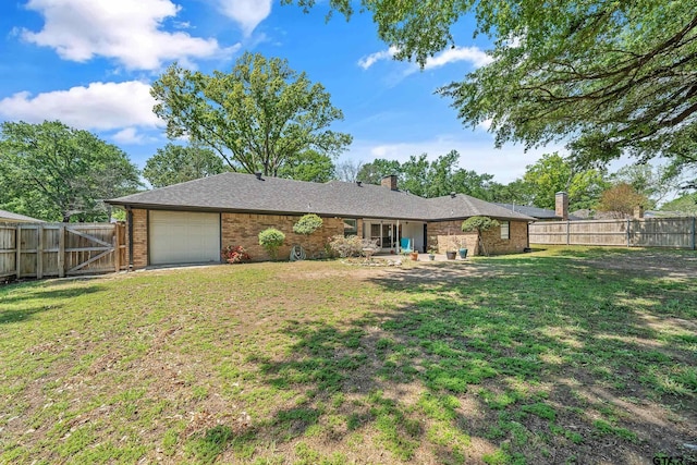 view of front of property featuring a chimney, an attached garage, a front lawn, a fenced backyard, and a gate