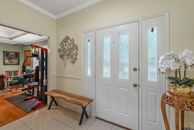 entrance foyer featuring ornamental molding and light tile patterned flooring
