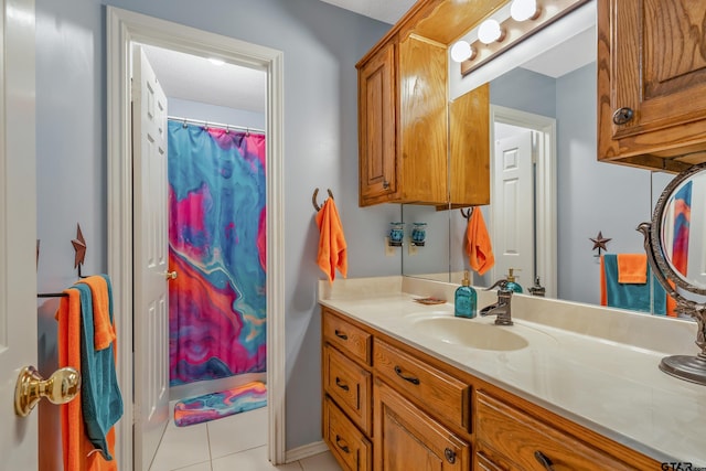 bathroom with tile patterned flooring, curtained shower, and vanity