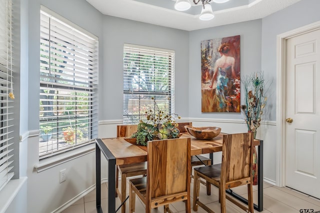 dining room with light tile patterned floors, a notable chandelier, and plenty of natural light