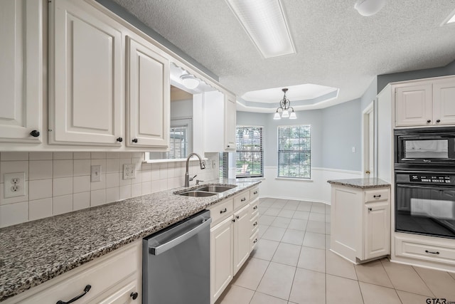 6214 Huntington Dr, Tyler, TX 75703 - kitchen with black appliances, a sink, a raised ceiling, a textured ceiling, and white cabinetry
