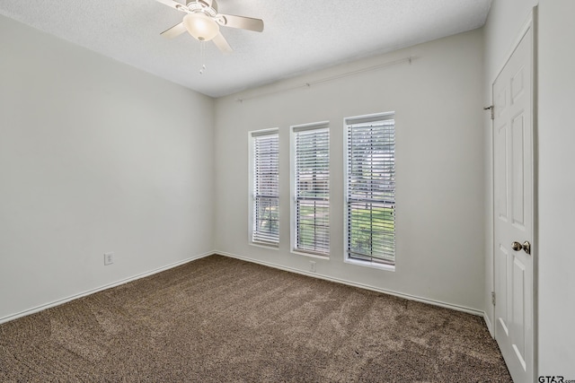 6214 Huntington Dr, Tyler, TX 75703 - unfurnished room featuring dark carpet, ceiling fan, and a textured ceiling