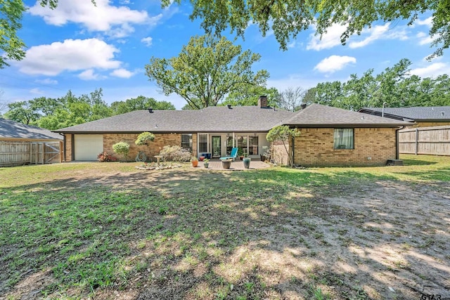 6214 Huntington Dr, Tyler, TX 75703 - back of house featuring brick siding, a chimney, a garage, and a patio