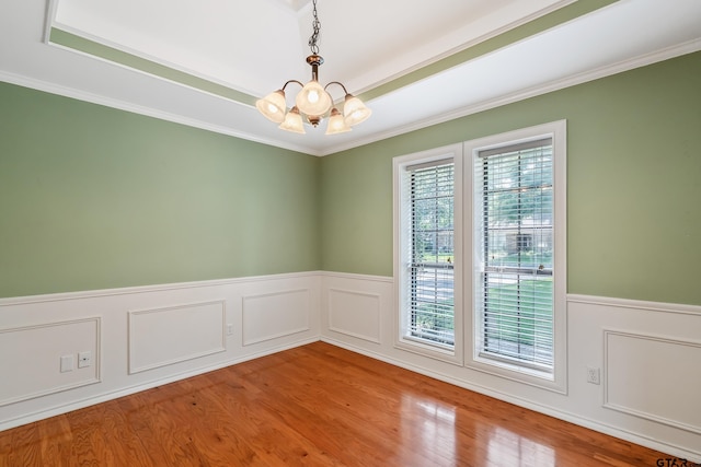 6214 Huntington Dr, Tyler, TX 75703 - unfurnished room featuring a chandelier, a wainscoted wall, ornamental molding, and wood finished floors