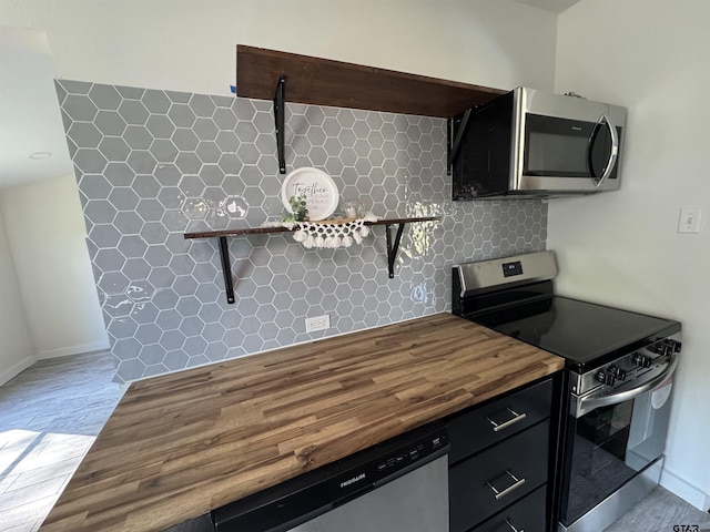 1314 N Queen St, Palestine, TX 75803 - kitchen with tasteful backsplash, open shelves, wooden counters, stainless steel appliances, and baseboards