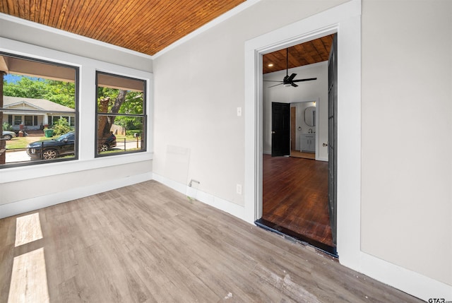 1314 N Queen St, Palestine, TX 75803 - spare room featuring baseboards, ceiling fan, wood ceiling, crown molding, and wood finished floors