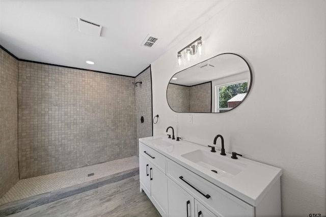 1314 N Queen St, Palestine, TX 75803 - bathroom featuring a tile shower, a sink, visible vents, and double vanity
